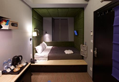 a bedroom with a bed with a green wall at Newport in Dnipro