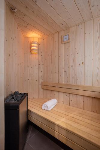 a sauna with a bench in a wooden room at Résidence Daria-I Nor by les Etincelles in L'Alpe-d'Huez