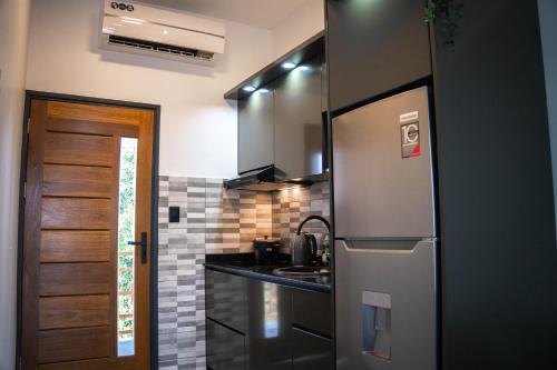 a kitchen with a stainless steel refrigerator and a sink at Yasmin Luxury Resort in Paramaribo