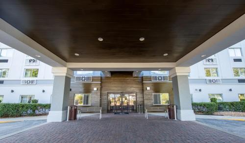 a large building with benches in front of it at Holiday Inn Express & Suites Clermont SE - West Orlando by IHG in Orlando