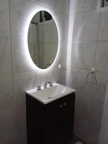 a bathroom with a sink and a mirror at Cabaña entera in Río Grande