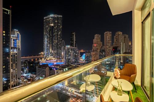 a view of a city skyline at night from a balcony at Elite Waterfront 3BR Haven - Marina and Sea Views! in Dubai