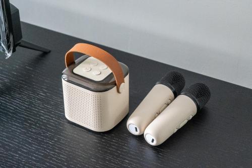 a speaker with two microphones and a remote control at Kuala Lumpur luxury MRT Suntex in Cheras
