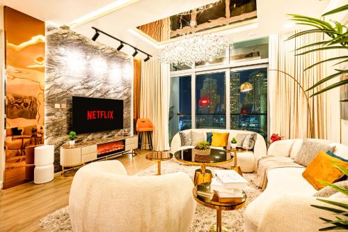 a living room with a couch and a tv at Elite Waterfront 3BR Haven - Marina and Sea Views! in Dubai