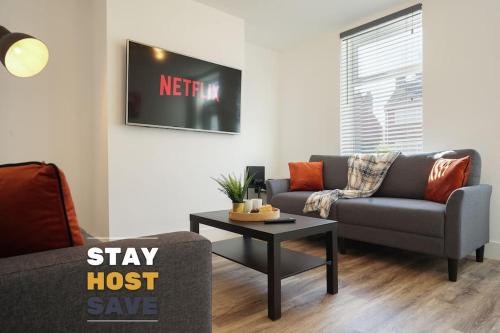 a living room with a couch and a table at Beighton - 3 Bed Spacious Home with FREE Parking, Great for Groups & Families - Hosted by Stay Host Save in Sheffield