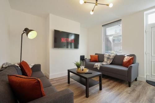 a living room with a couch and a table at Beighton - 3 Bed Spacious Home with FREE Parking, Great for Groups & Families - Hosted by Stay Host Save in Sheffield