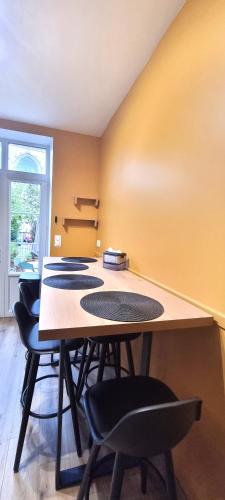 a conference room with a table and chairs at La maison GUILLAUME in Falaise