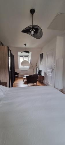 a bedroom with a bed and a pool table at La maison GUILLAUME in Falaise