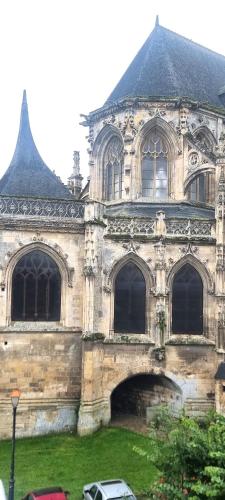 an old stone building with a lot of windows at La maison GUILLAUME in Falaise