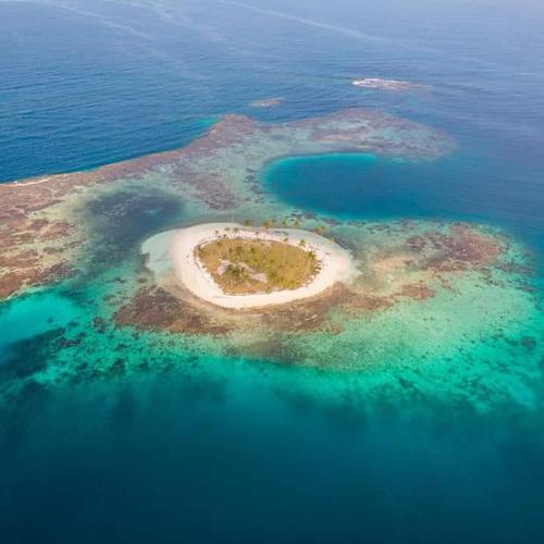 a small island in the ocean in the water at Catamaran in San Blás Islands, private boat in Waisalatupo