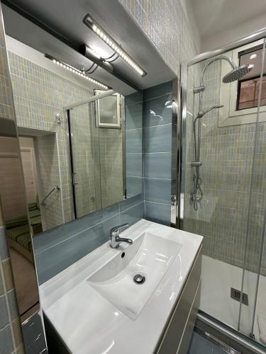 a bathroom with a white sink and a shower at Casetta del Granatello in Portici