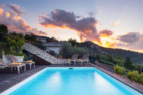 a swimming pool with a stairway leading to a sunset at Villa Golfo Di Napoli With Private Pool in Colli di Fontanelle