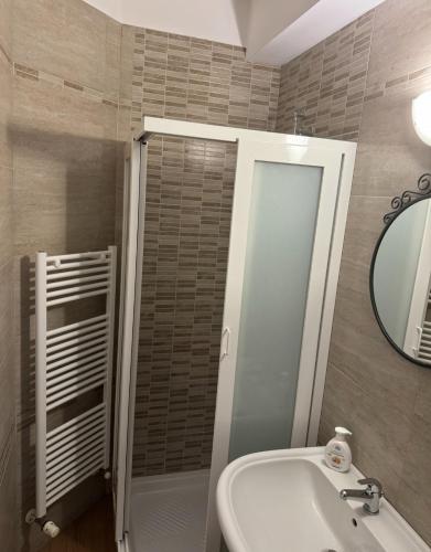a bathroom with a shower and a sink and a mirror at Casa Gioia in Taranto