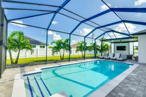 a swimming pool with a glass roof over a house at Furnished Lanai and Private Pool Cape Coral Home in Cape Coral