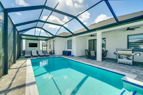 an indoor swimming pool with a glass roof at Furnished Lanai and Private Pool Cape Coral Home in Cape Coral