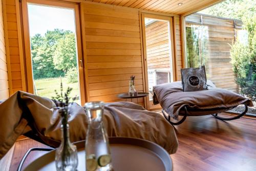 a room with a bed and a window with a sink at Sapia Hotel Rheinsberg in Bad Säckingen