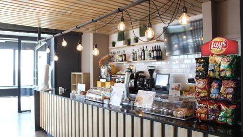 a restaurant with a counter with food and drinks at Residencia Universitaria Resa Erasmo in Madrid