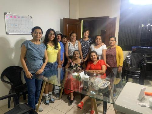 a group of women standing around a glass table at HOSTAL SAN MARINO in Manta