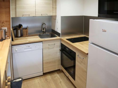 une cuisine avec un réfrigérateur blanc et un évier dans l'établissement Appartement ski-in/ski-out 6 pers, balcon, proche jardin d'enfants - FR-1-322-204, aux Orres
