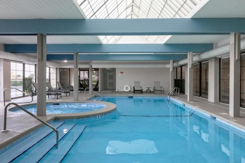 a large swimming pool in a building with a large ceiling at Bluewater Vacation Rentals in Orange Beach