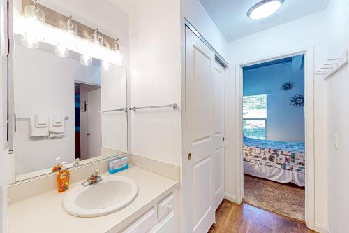 a white bathroom with a sink and a mirror at Chamonix 20 in Mammoth Lakes