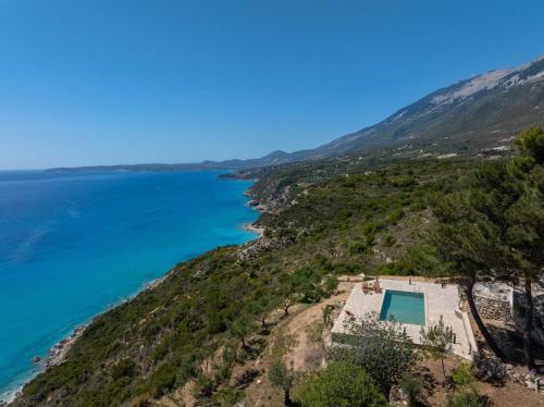 an aerial view of a beach with a house and the ocean at Skali Retreat in Atsoupádhes