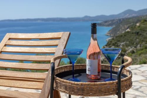 a bottle of wine and two glasses on a chair at Skali Retreat in Atsoupádhes