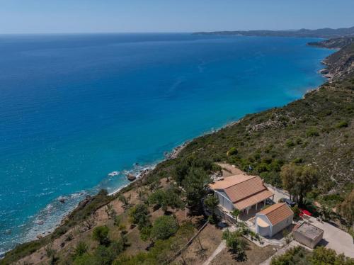 an aerial view of a house on a hill next to the ocean at Skali Retreat in Atsoupádhes