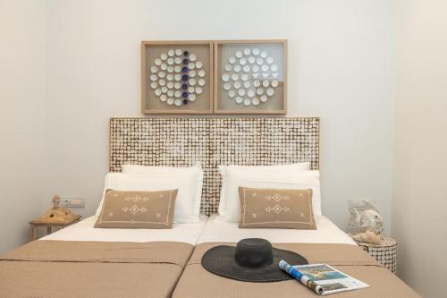 a bedroom with a bed with a hat on it at Skali Retreat in Atsoupádhes
