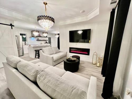 a living room with a white couch and a chandelier at Gorgeous view house in Gainesville