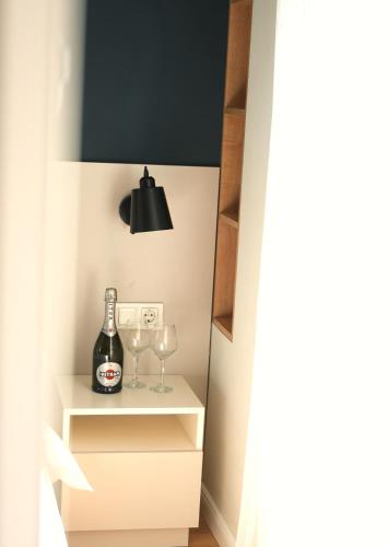 a room with a bottle of wine and two glasses at Sweet Home Apart-Hotel in Yerevan