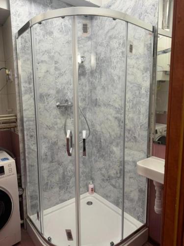 a shower with a glass enclosure in a bathroom at Paris Rooms -Rynek Centrum -F VAT in Kielce