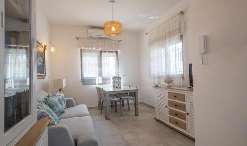a living room with a couch and a table at BAIA DELLE AGAVI in Taranto