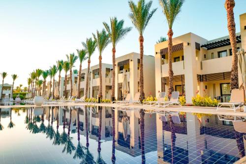 a resort with palm trees and a swimming pool at Sentido Reef Oasis Aqua Park Resort in Sharm El Sheikh
