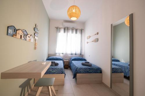 a small room with two beds and a table at BAIA DELLE AGAVI in Taranto