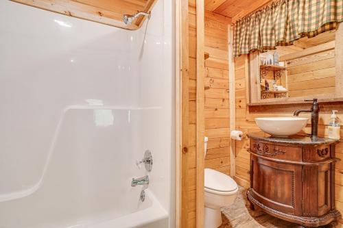 a bathroom with a sink and a toilet and a tub at North Georgia Mtn Escape with Hot Tub and Games! in Sautee Nacoochee