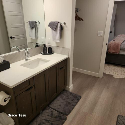a bathroom with a sink and a mirror at Cozy Cove Retreat Escape to Tranquility Stay in Simplicity in Dead Man's Flats