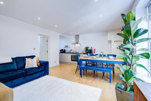a living room with a blue couch and a blue table at Ethelbert Lodge - Arree Stays in Margate