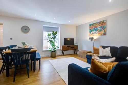 a living room with a couch and a table at Ethelbert Lodge - Arree Stays in Margate