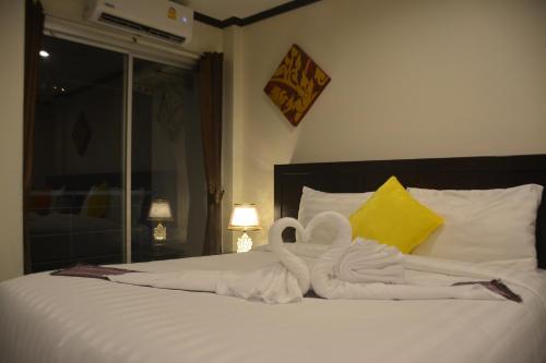 a bed with a swan made out of towels at Patong Moon Inn Residence in Patong Beach