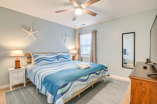 a bedroom with a bed and a ceiling fan at 1st-Floor Condo with Pool on Intracoastal Waterway! in Myrtle Beach
