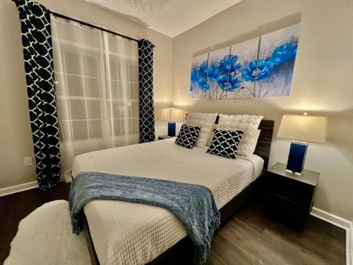 a bedroom with a bed with two lamps and a window at Lake Lanier House 1 in Gainesville