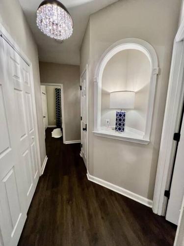a room with a hallway with a room with a door and a chandelier at Lake Lanier House 1 in Gainesville