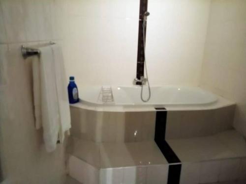 a bathroom with a sink with a faucet at Kimi's Place Lodge in Mzuzu