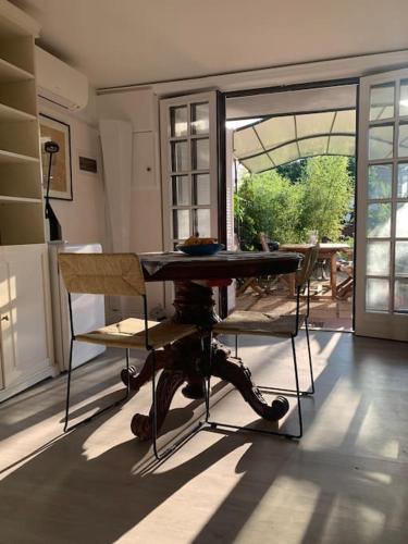 a kitchen with a table and chairs in a room at Le Bodole in Viareggio