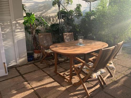 a wooden table and chairs on a patio at Le Bodole in Viareggio
