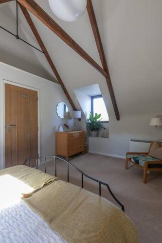 a bedroom with a bed and a living room at The Loft in Faygate