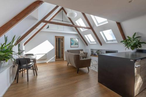 a living room with skylights and a table and chairs at The Loft in Faygate