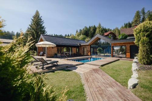 a home with a swimming pool and a house at Chalet Annelies Ramsau am Dachstein in Ramsau am Dachstein
