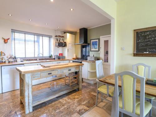 a kitchen with a wooden counter top and a table at Hendre in Blaenau-Ffestiniog